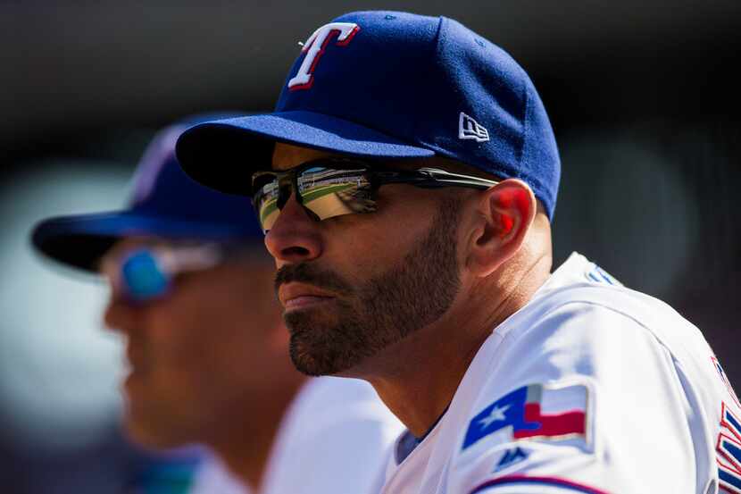 Texas Rangers manager Chris Woodward (8) watches the game from the dugout during the fifth...