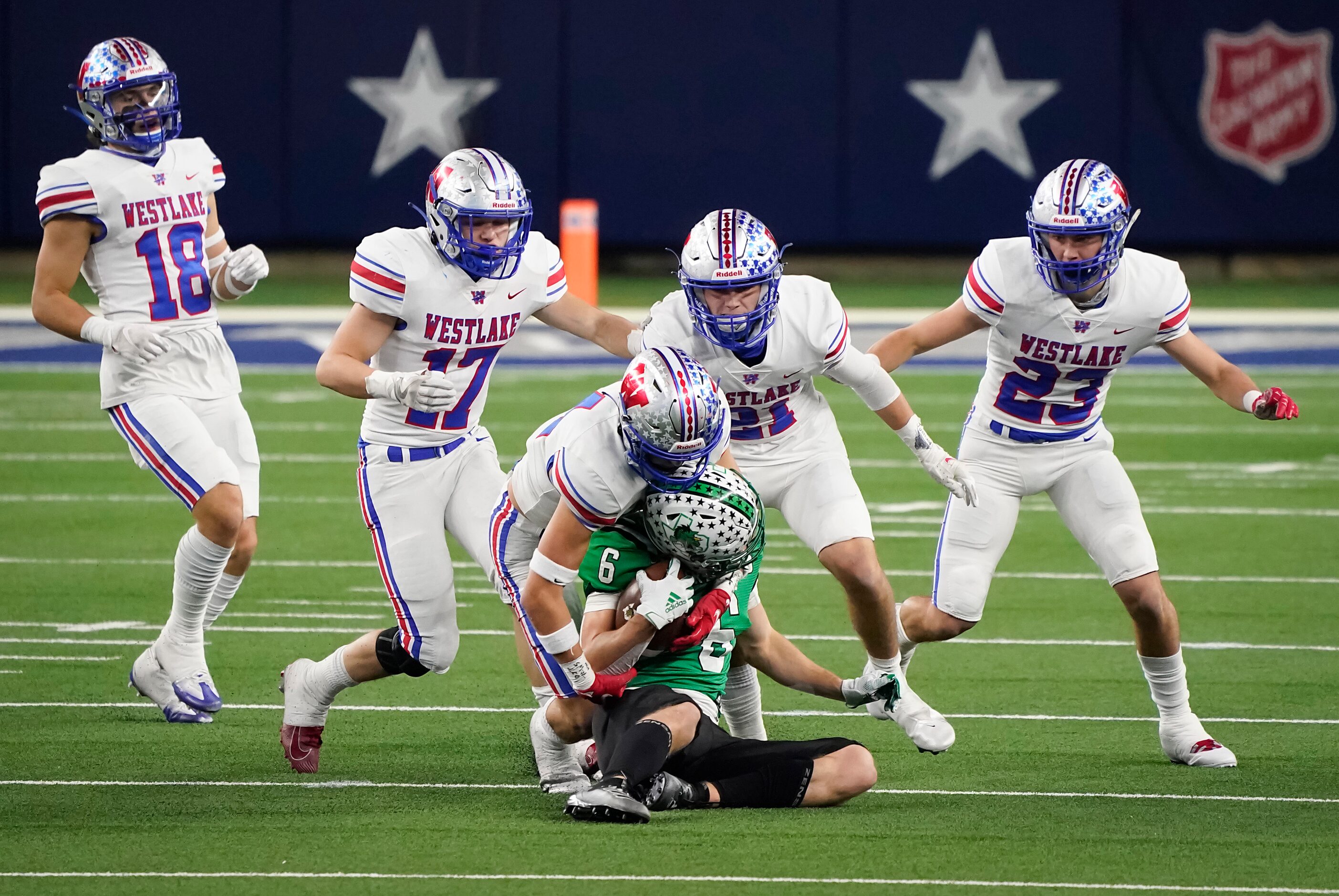 Southlake Carroll wide receiver Landon Samson (6) is brought down by Austin Westlake...