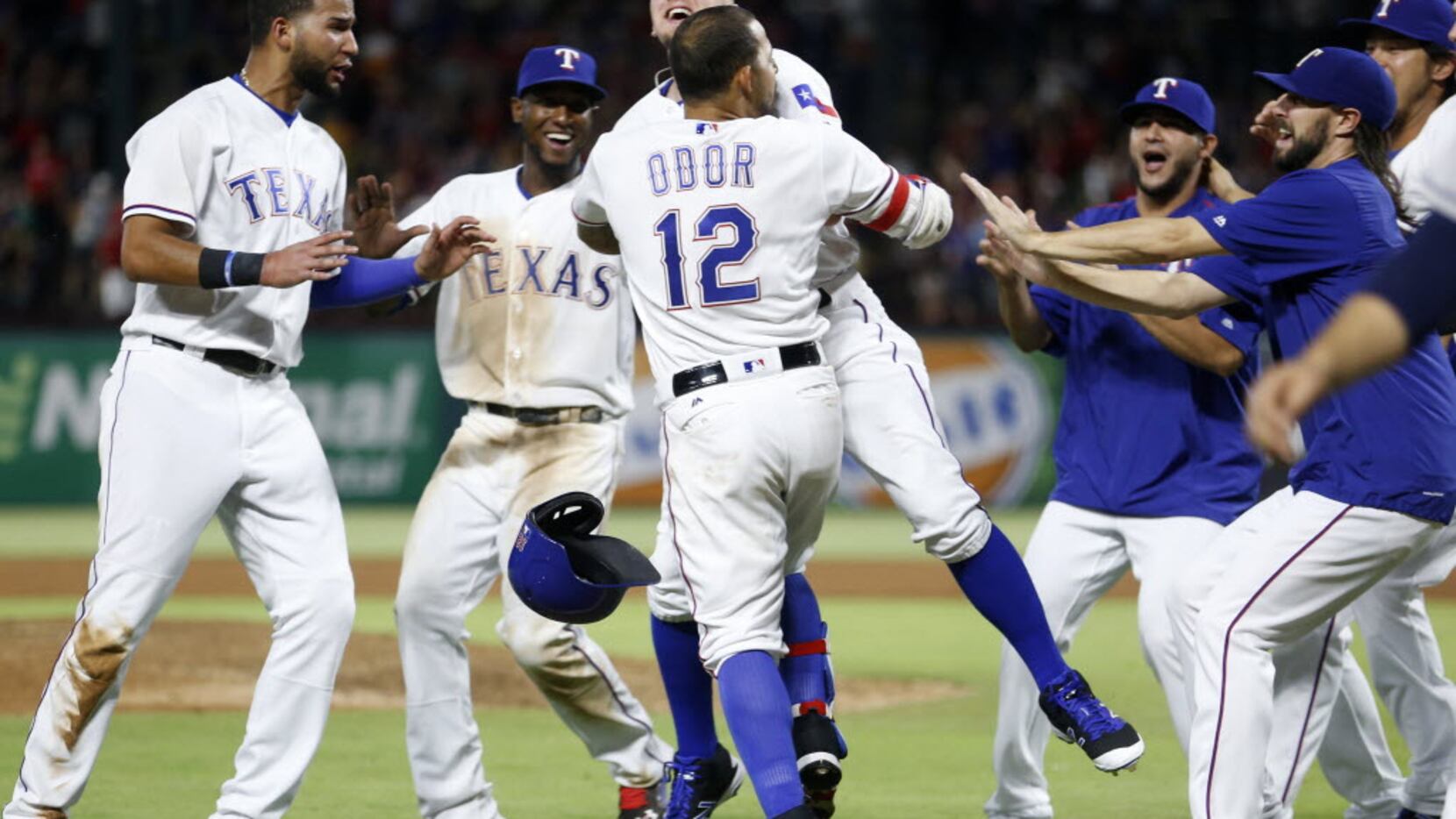 Texas Rangers second baseman Rougned Odor (12) celebrates with teammates after scoring on a...