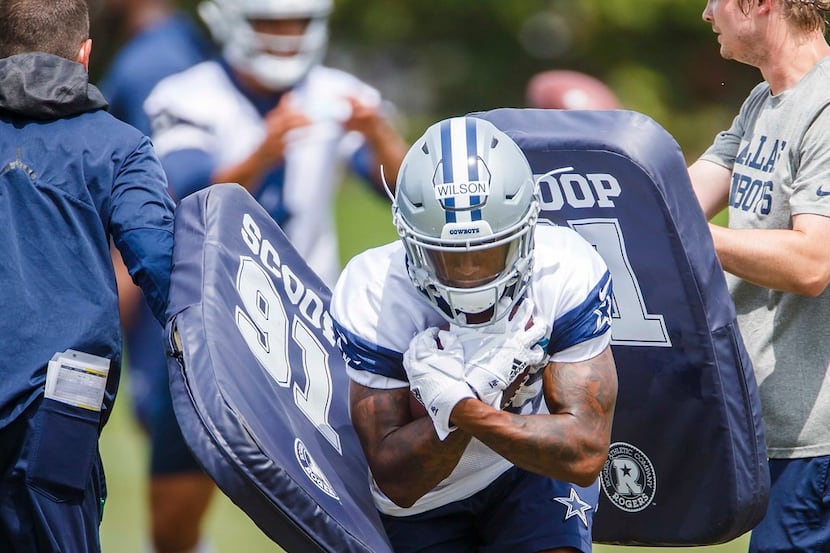 Dallas Cowboys wide receiver Cedrick Wilson (16) runs a drill during the team's minicamp at...