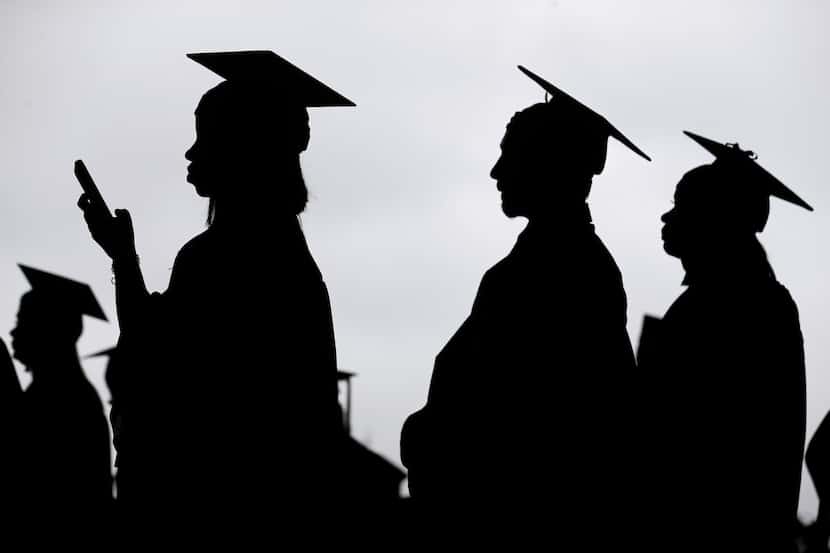 FILE - New graduates line up before the start of a community college commencement in East...