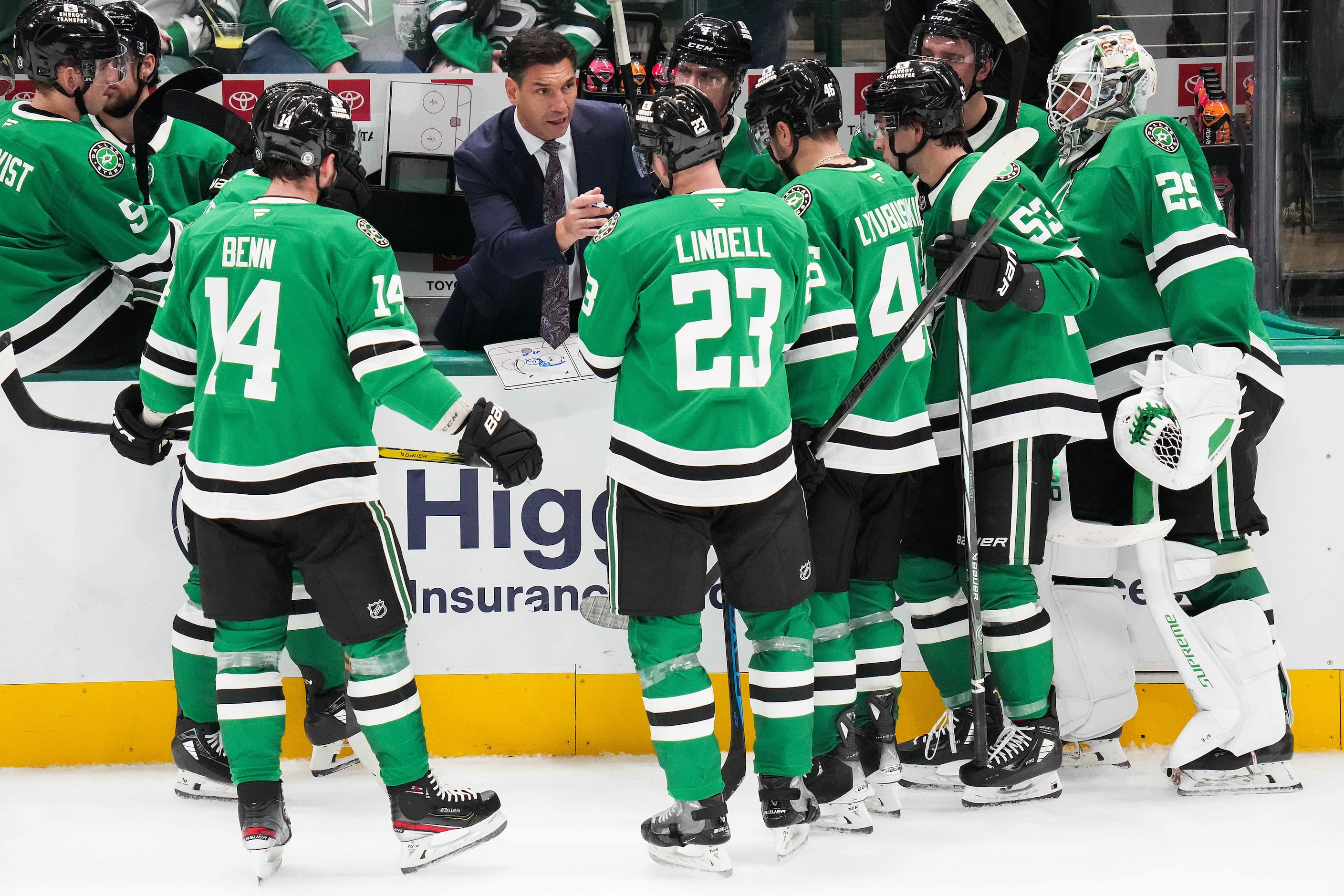 Dallas Stars players huddle around assistant coach Alain Nasreddine during a time out in the...