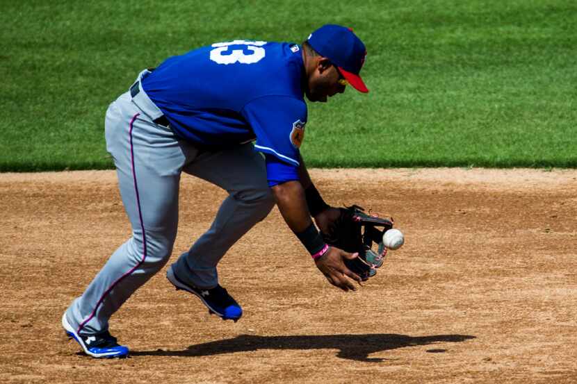 Texas Rangers third baseman Josh Morgan (93) chases a ground ball during the third inning of...