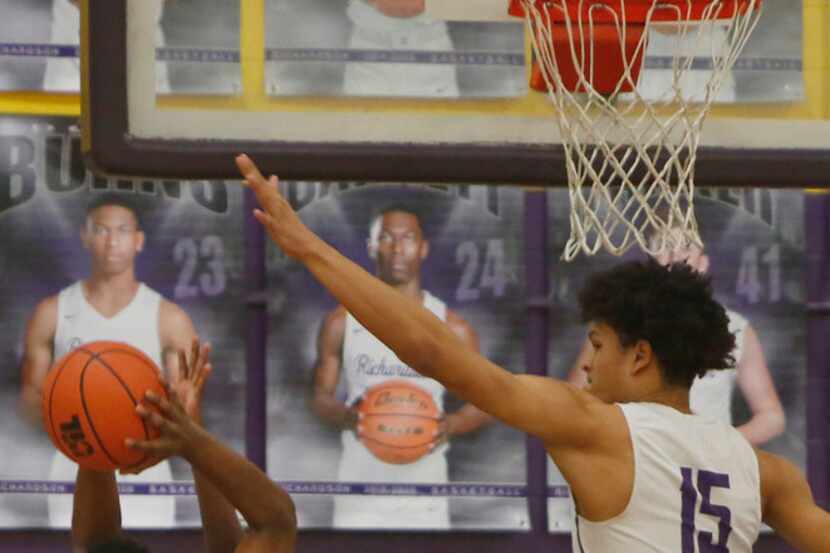 Richardson Berkner's Micah Law (12) is challenged by Richardson defenders Dequinton Williams...