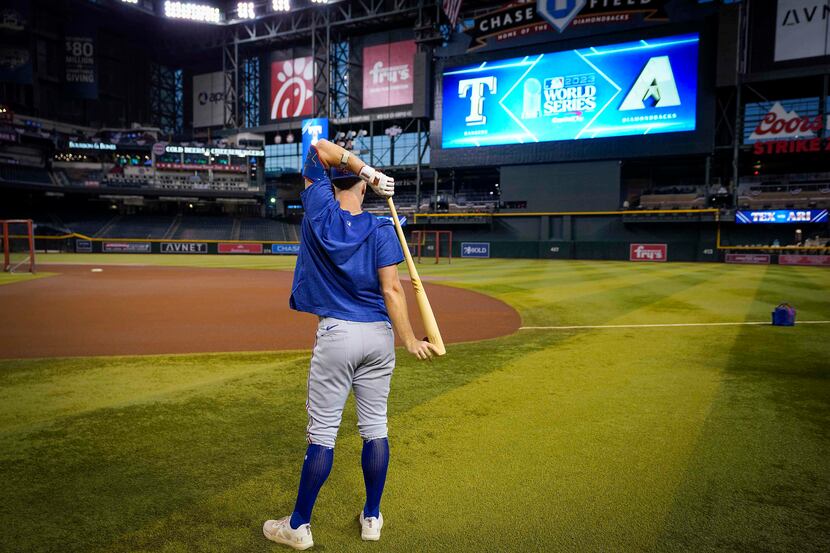 Texas Rangers third baseman Josh Jung stretches prior to a workout at Chase Field in...