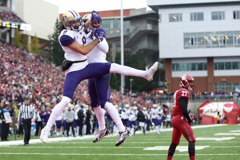 Washington's Dante Pettis and John Ross celebrate Pettis' touchdown in the first quarter to...