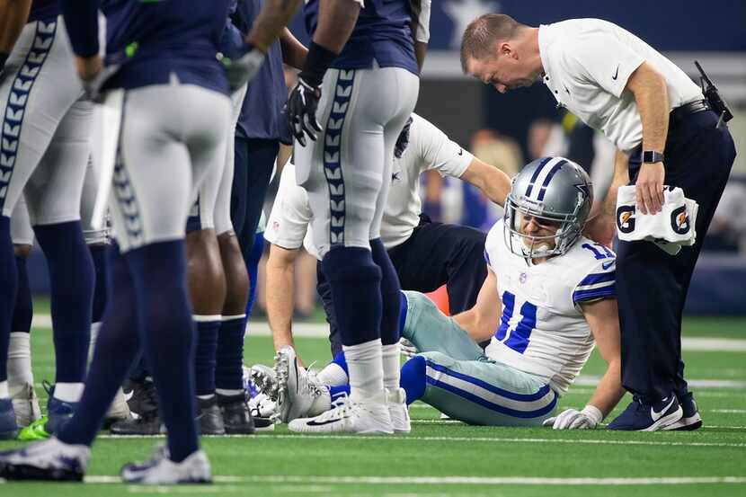 Dallas Cowboys wide receiver Cole Beasley (11) receives medical attention after being...