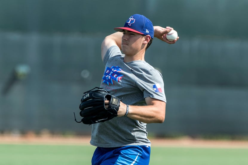 FILE - Rangers pitcher Cole Winn does a little long toss at the team's training facility in...