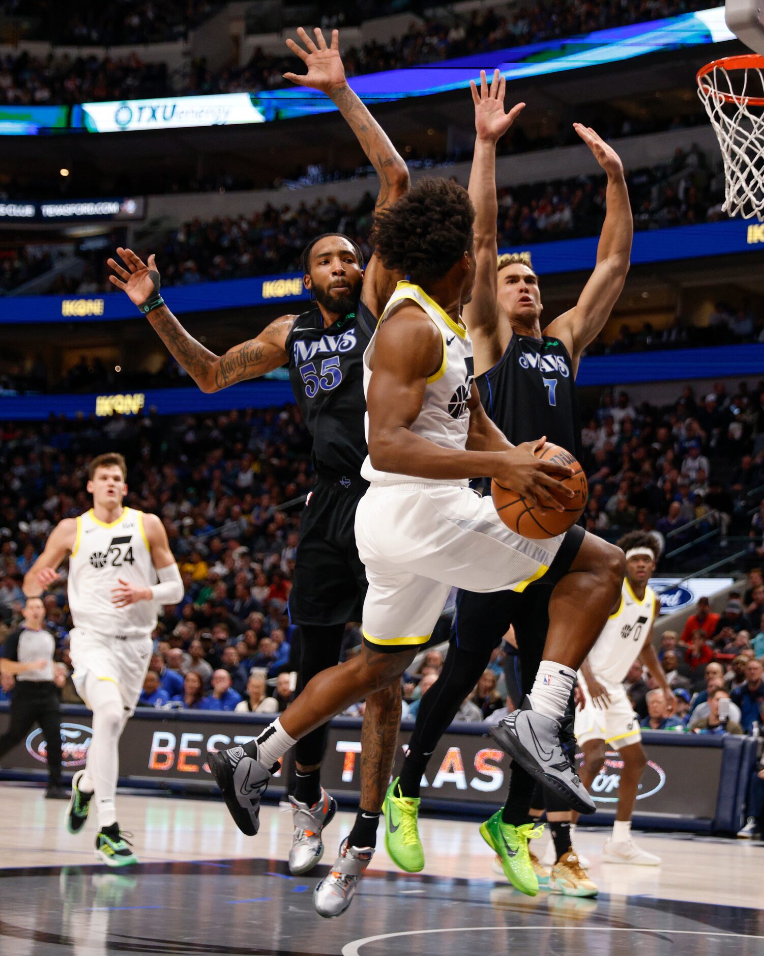 Dallas Mavericks forward Derrick Jones Jr. (55) and center Dwight Powell (7) defend against...