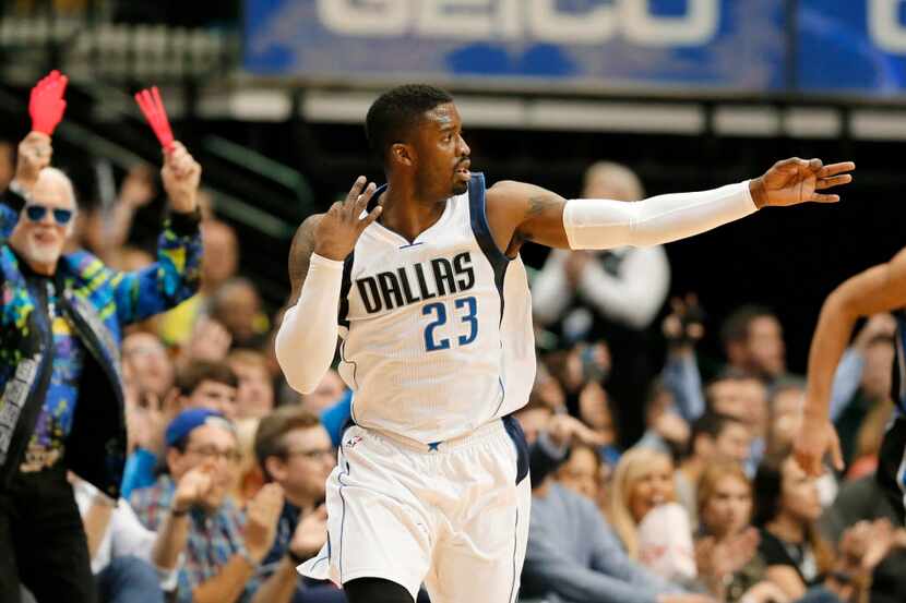 Dallas Mavericks guard Wesley Matthews (23) celebrates sinking a three-point basket in the...