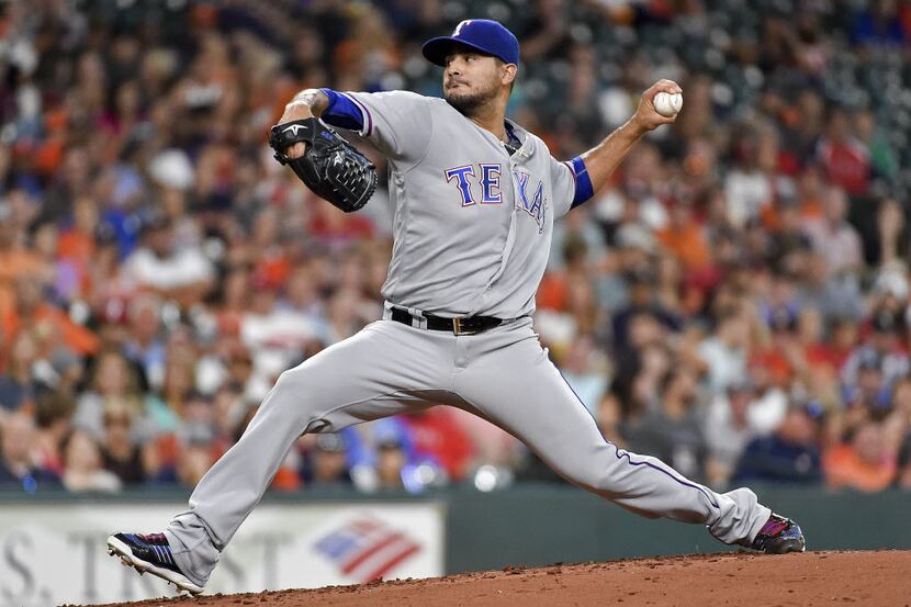 Texas Rangers starting pitcher Martin Perez delivers during the second inning of a baseball...