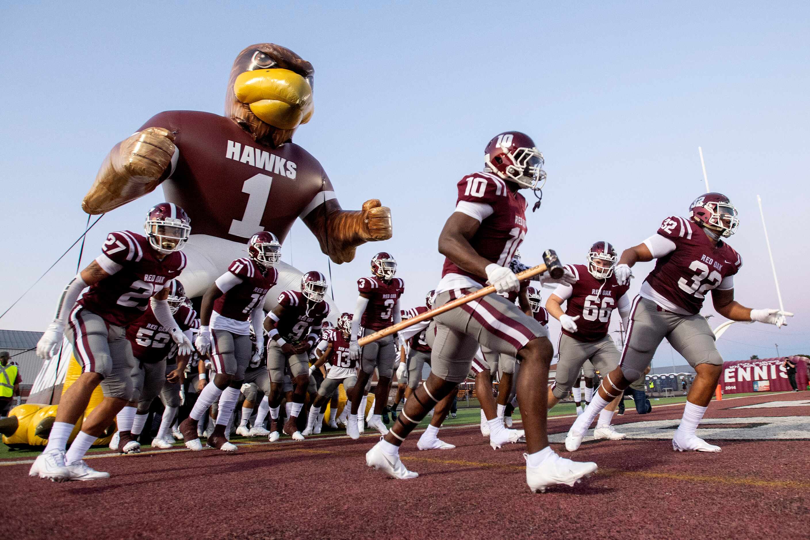Red Oak takes the field before a high school football game against Ennis on Friday,...