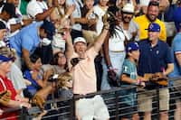 Joe Deane of Alvin, Texas reacts after catching a home run off the bat of Texas Rangers...