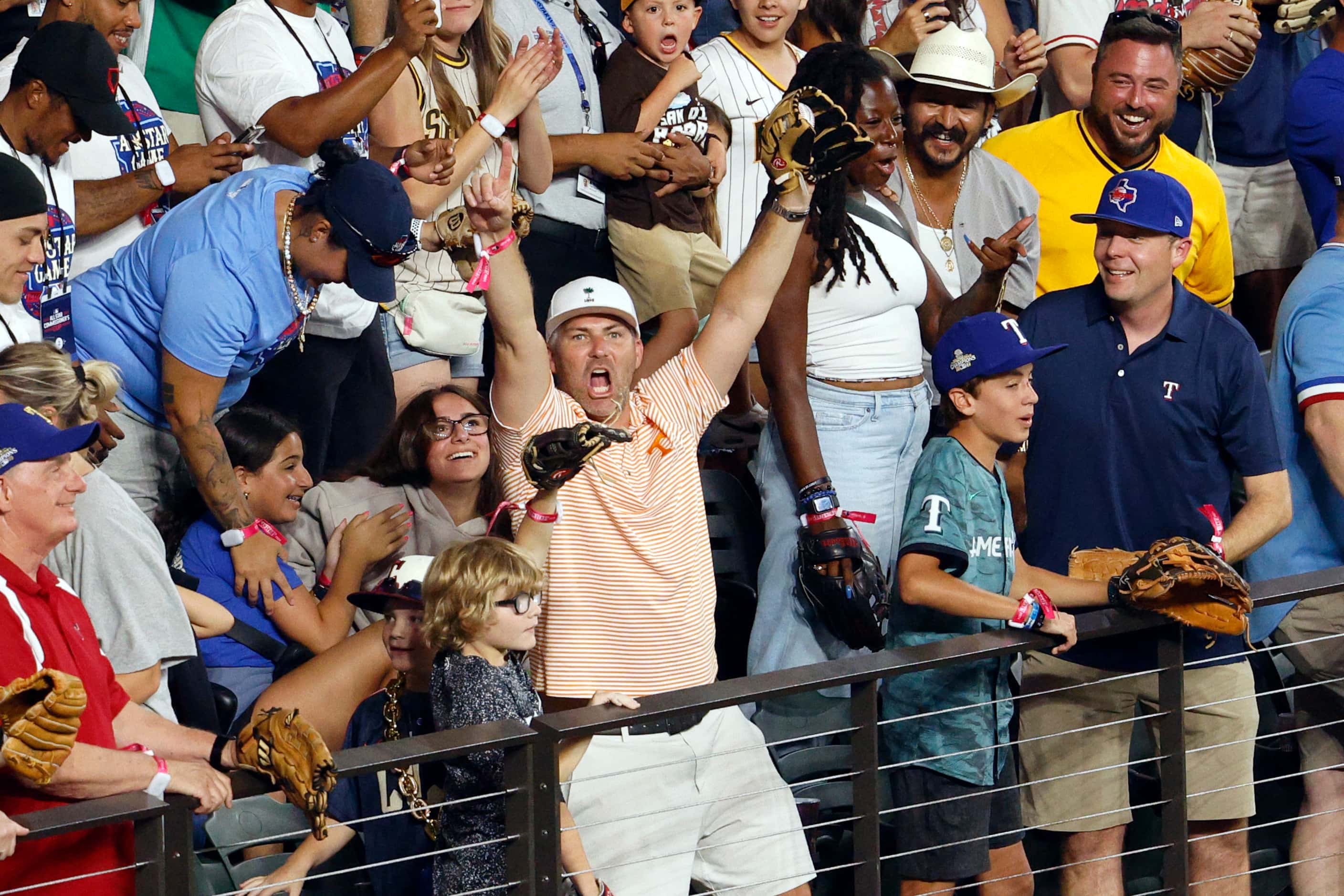 Joe Deane of Alvin, Texas reacts after catching a home run off the bat of Texas Rangers...