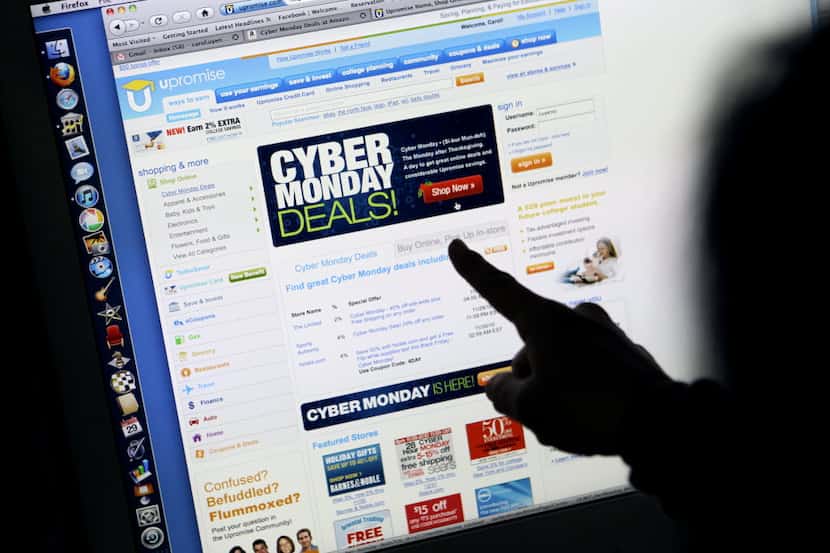 FILE - In this Monday, Nov. 29, 2010, file photo, a consumer looks at Cyber Monday sales on...