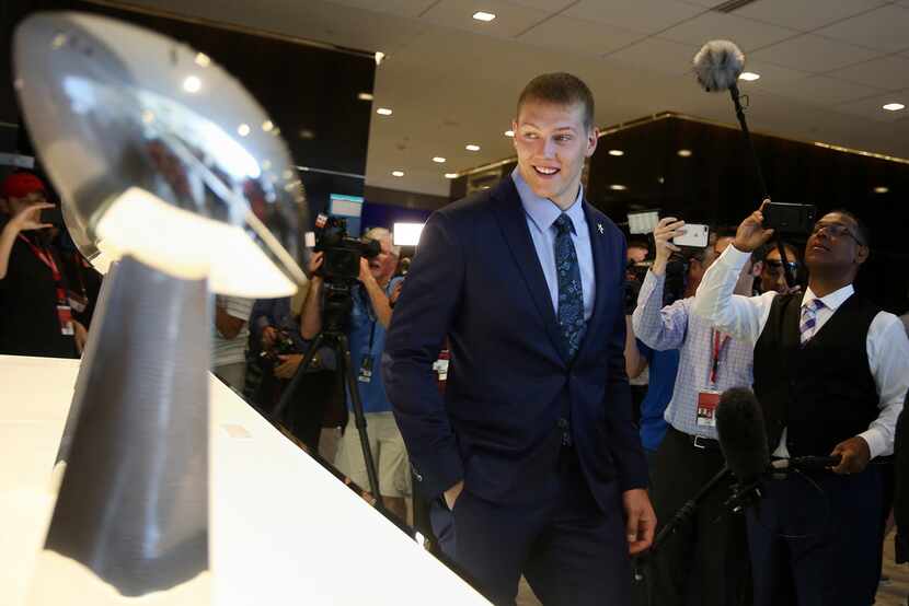 Boise State linebacker Leighton Vander Esch looks at Super Bowl trophies after arriving at...