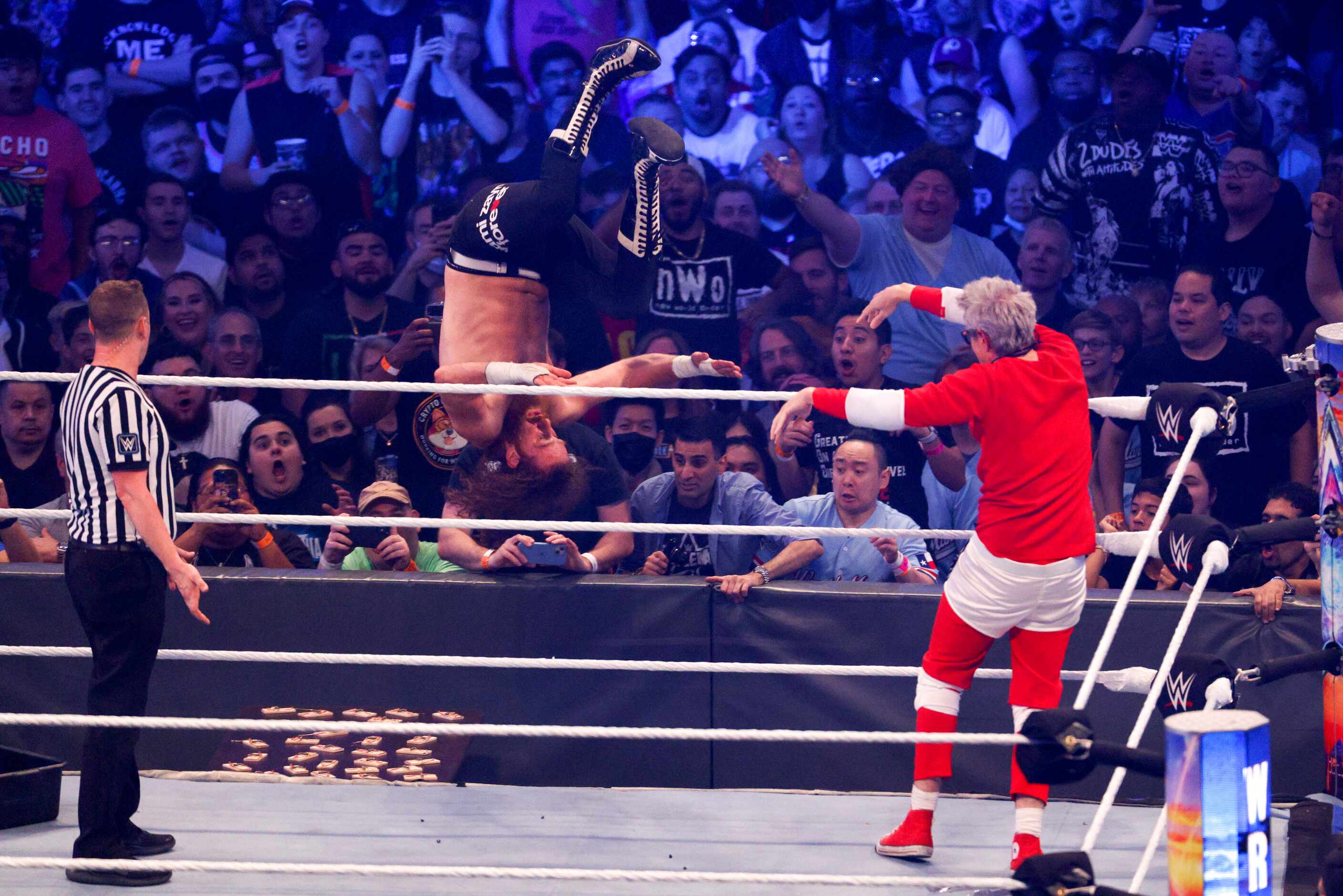 Johnny Knoxville (right) throws Sami Zayn out of the ring during a match at WrestleMania...