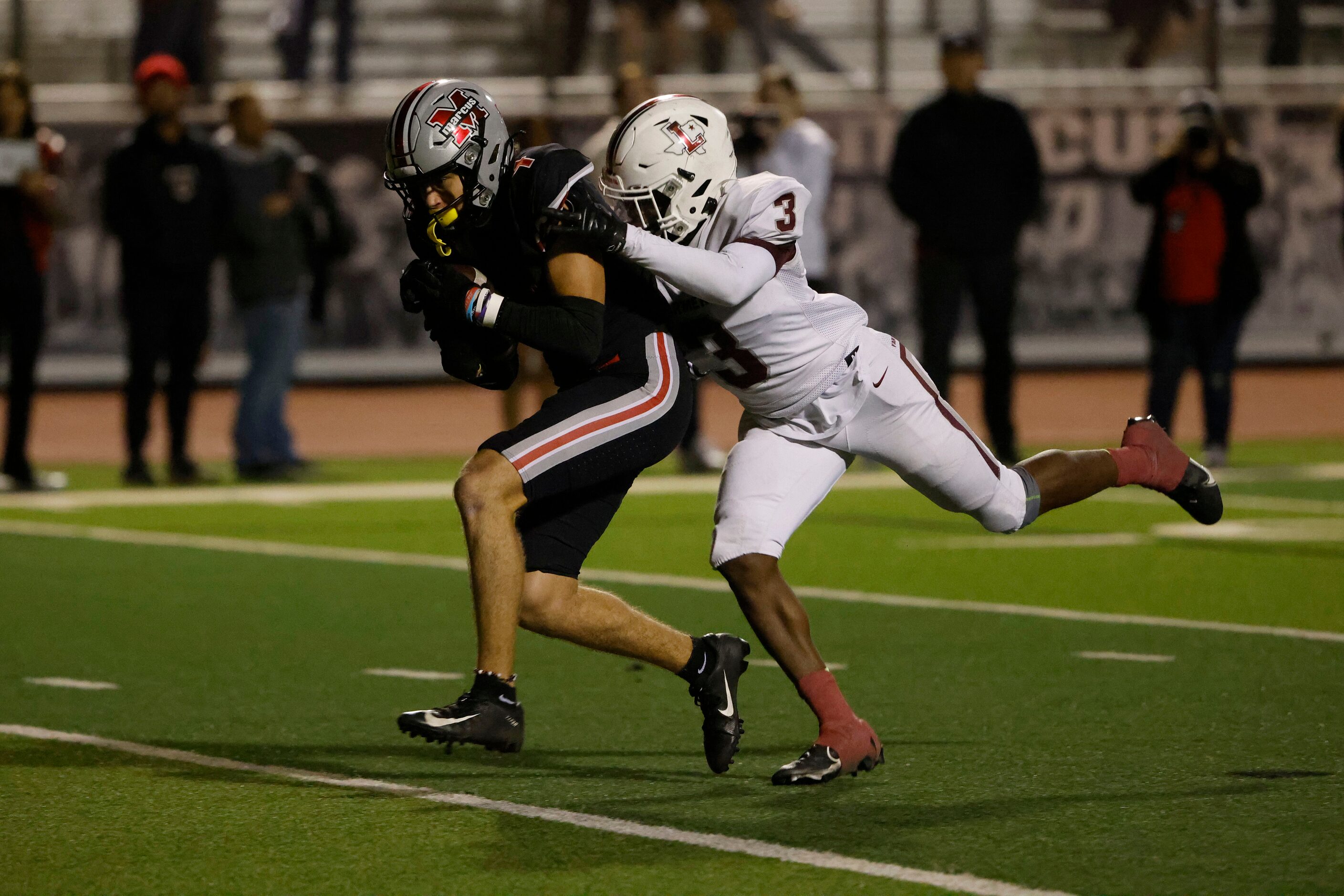 Flower Mound Marcus receiver Isaac Khattab (4) scores a touchdown in front of Lewisville...