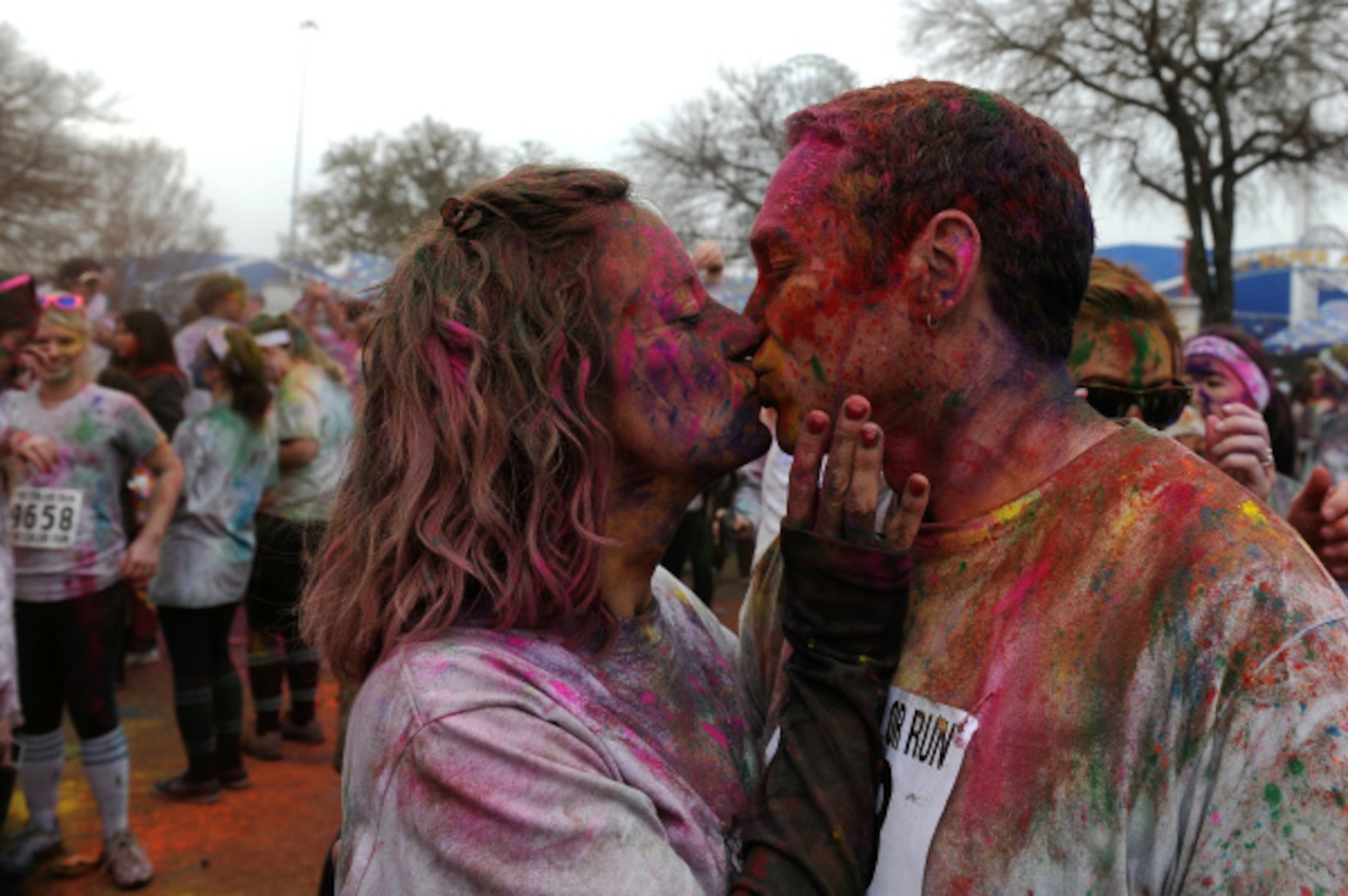 Jennifer Golden, left, and Jerry Murray, right, both from Fort Worth, Kiss at the completion...