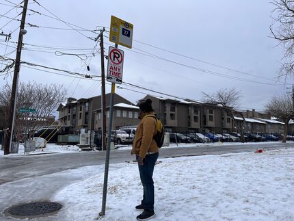 Johnathan Lane had to wait in the cold covered by freezing rain for the DART bus to take him...