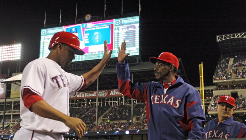 Texas Rangers starting pitcher Derek Holland looks on after giving up a three-run homer to...