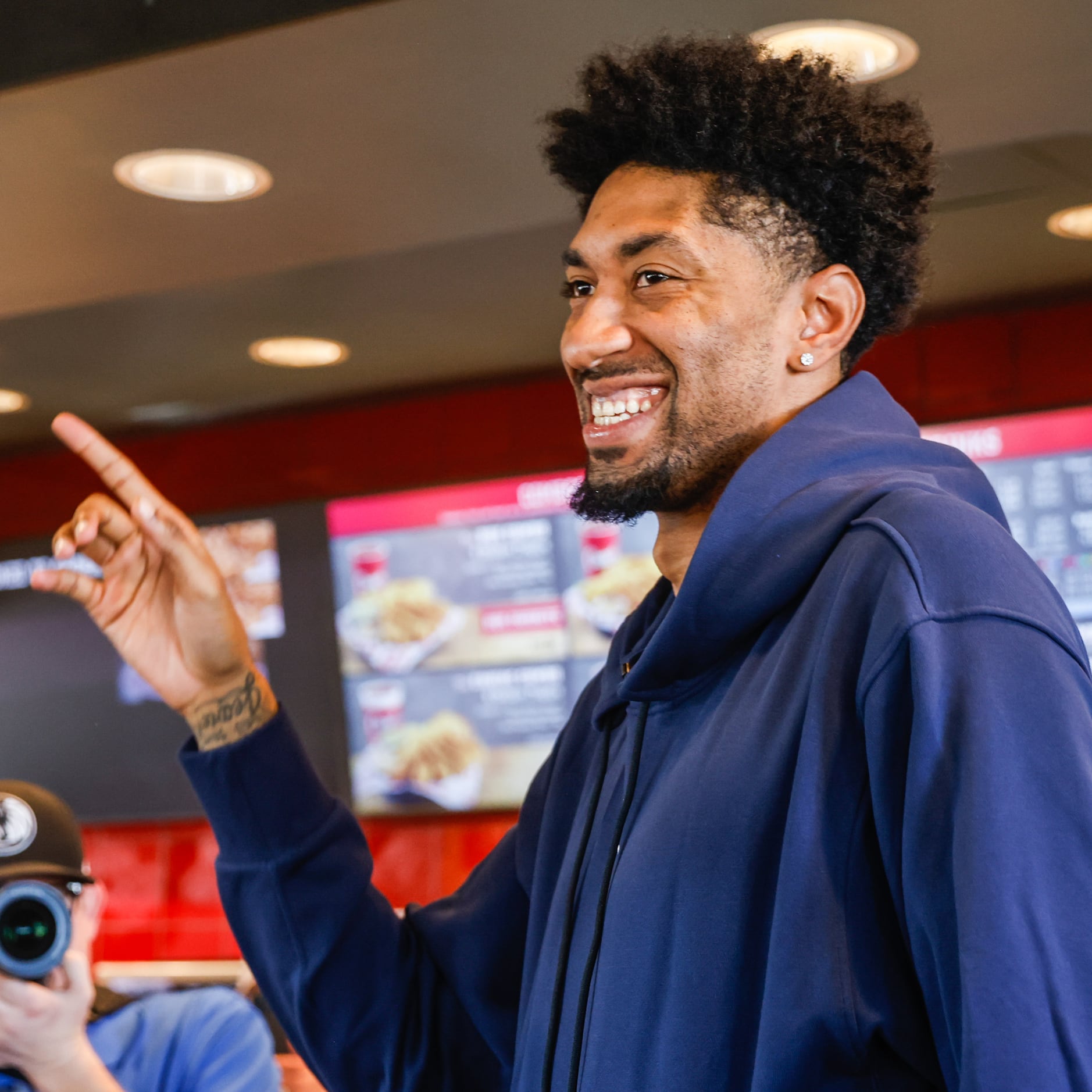 Mavericks player Christian Wood arrives to serve lunch at the Raising Cane’s in Dallas on...