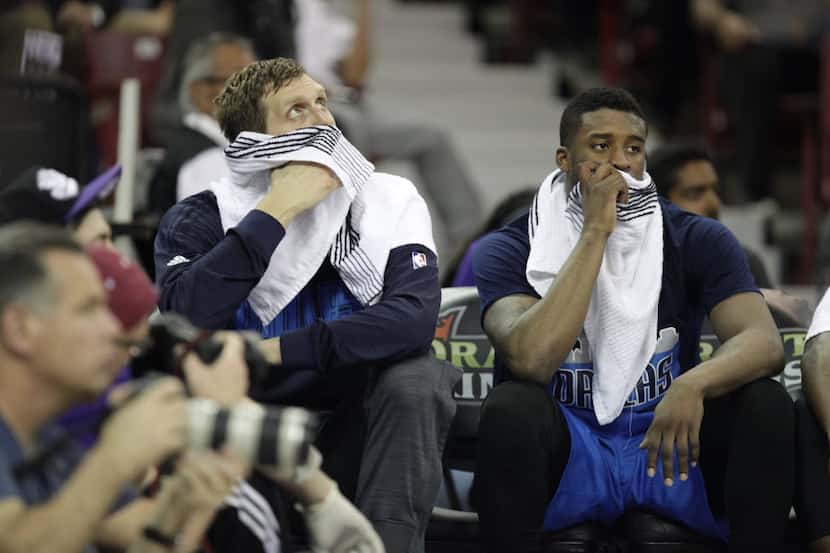 Dallas Mavericks players Dirk Nowitzki, left, and Wesley Matthews watch the last minutes of...