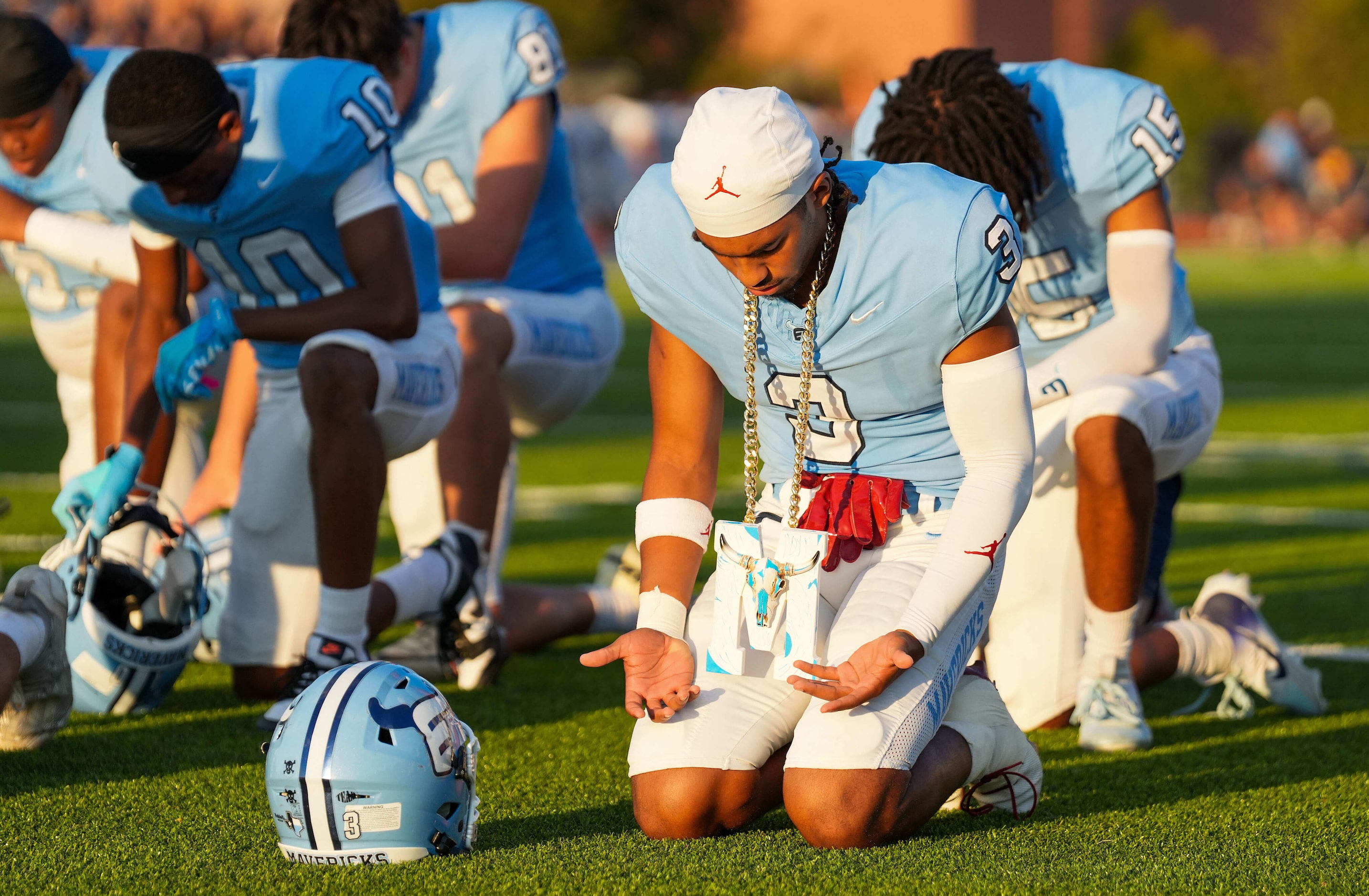 Frisco Emerson defensive back Maliek Hawkins (3) kneels in prayers before a District 4-5A...