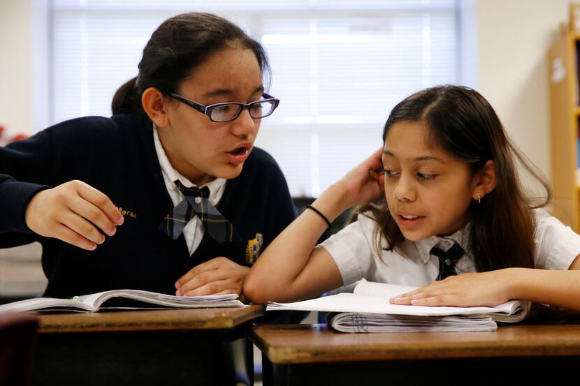Naomy Meraz (left) and Alejandra Gamez work on math problems together during class at Annie...