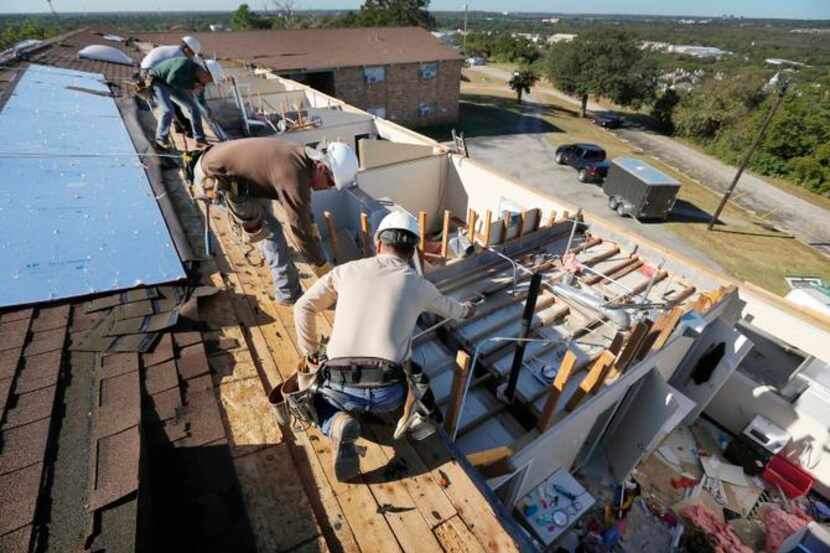 
Workers were busy reconstructing the roof on the women’s dormitory at Arlington Baptist...