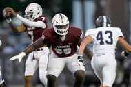 Lewisville offensive lineman Michael Fasusi (56), center, protects quarterback Ethan Terrell...