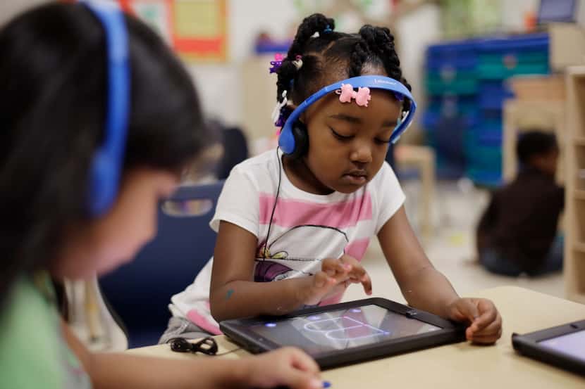 Prekindergarten students use electronic tablets at the South Education Center, in San...