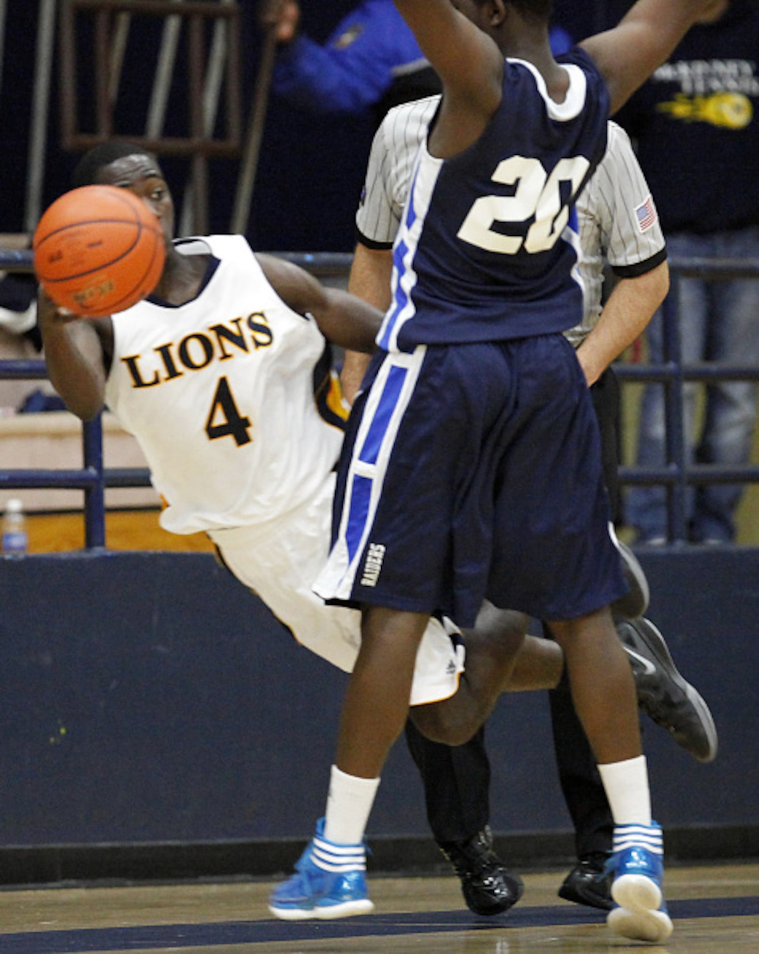 McKinney High School's A.J. Moutry (4) leaves his feet to pass the ball around Wylie East...