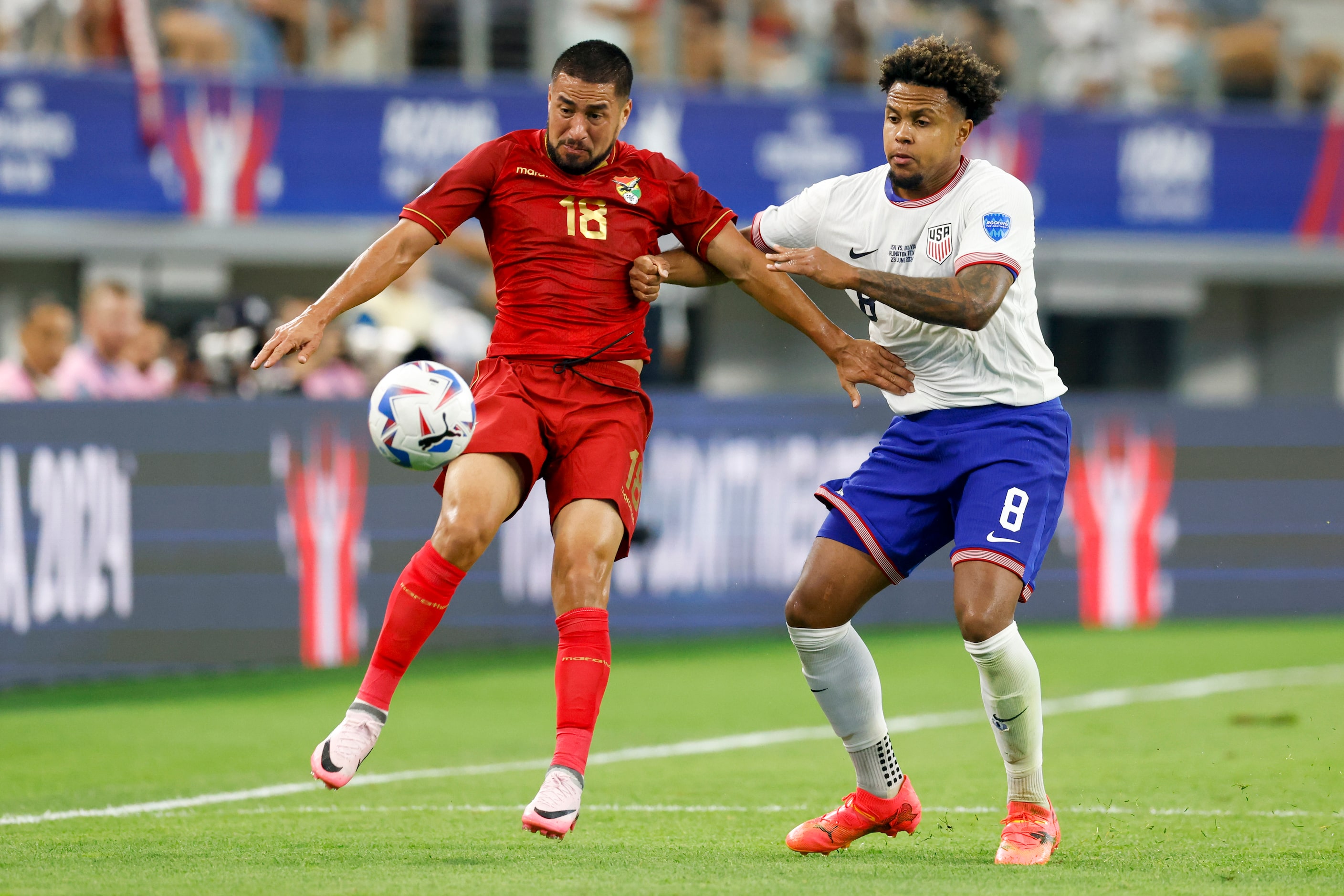 Bolivia forward Rodrigo Ramallo (18) and United States midfielder Weston McKennie (8) battle...