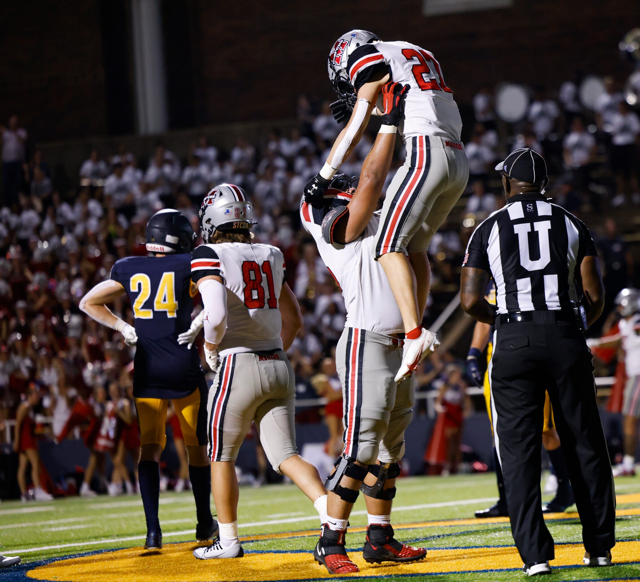 Flower Mound Marcus running back Chance Banner (27) is lifted as his team celebrates his...