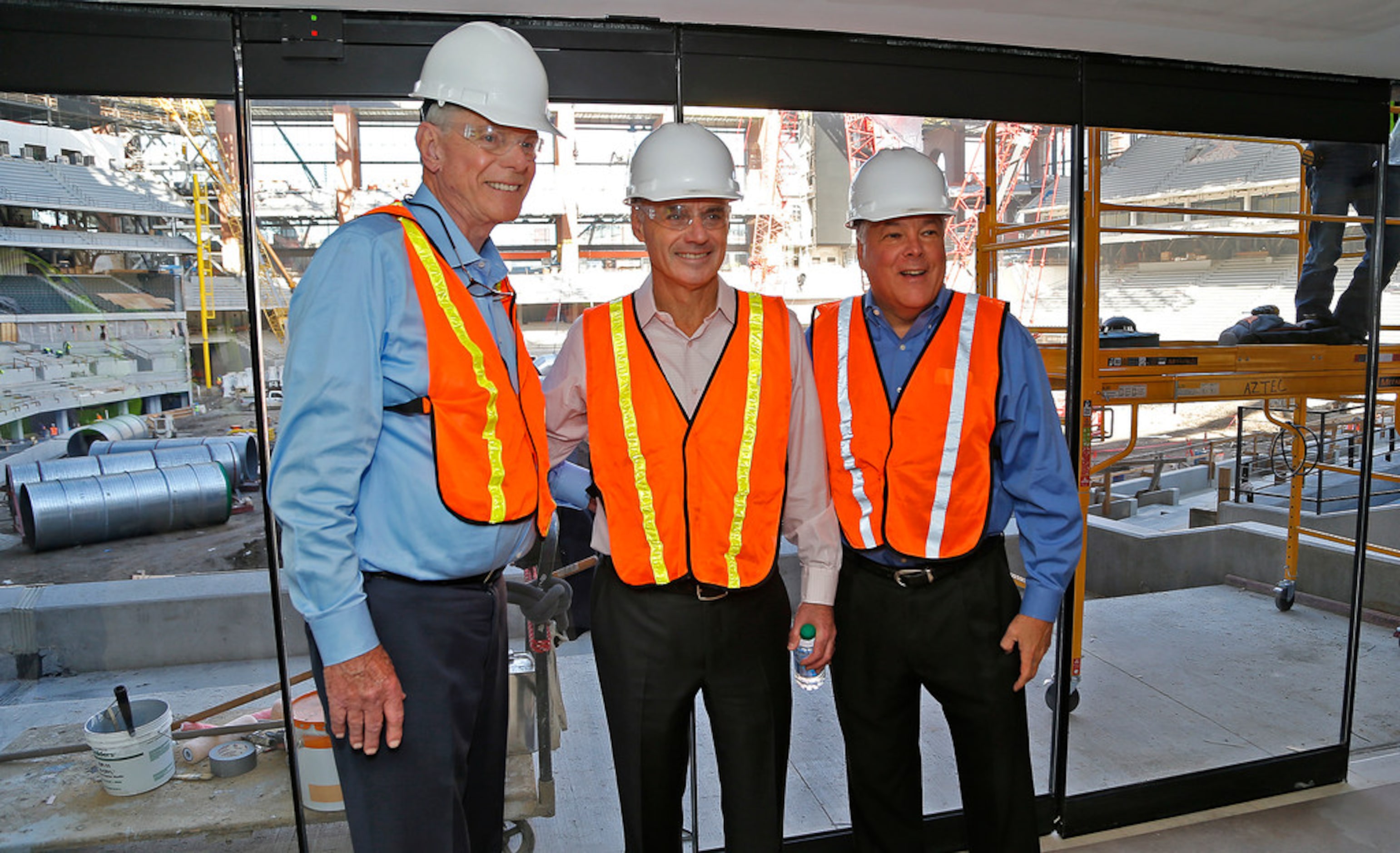 MLB commissioner Rob Manfred (center) stands with Texas Rangers owners Ray Davis (left) and...