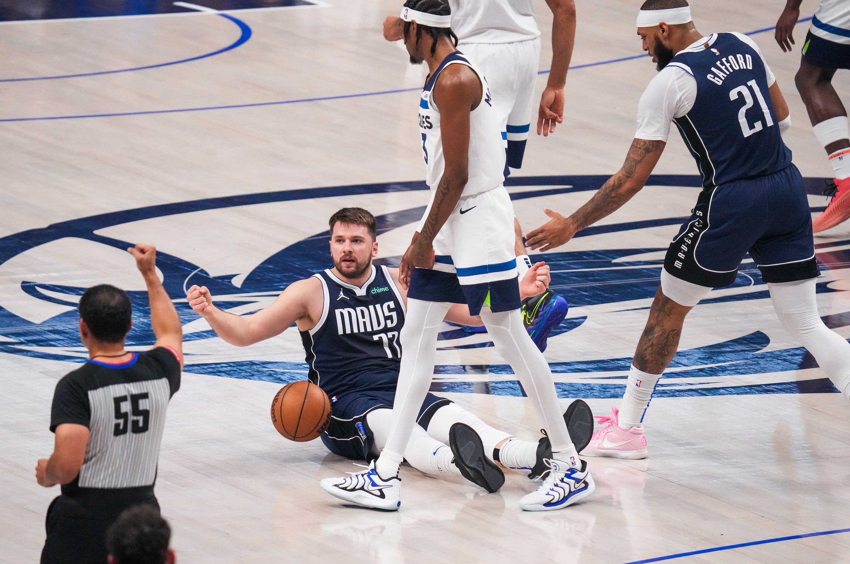 Dallas Mavericks guard Luka Doncic (77) looks for a call from referee Bill Kennedy (55)...