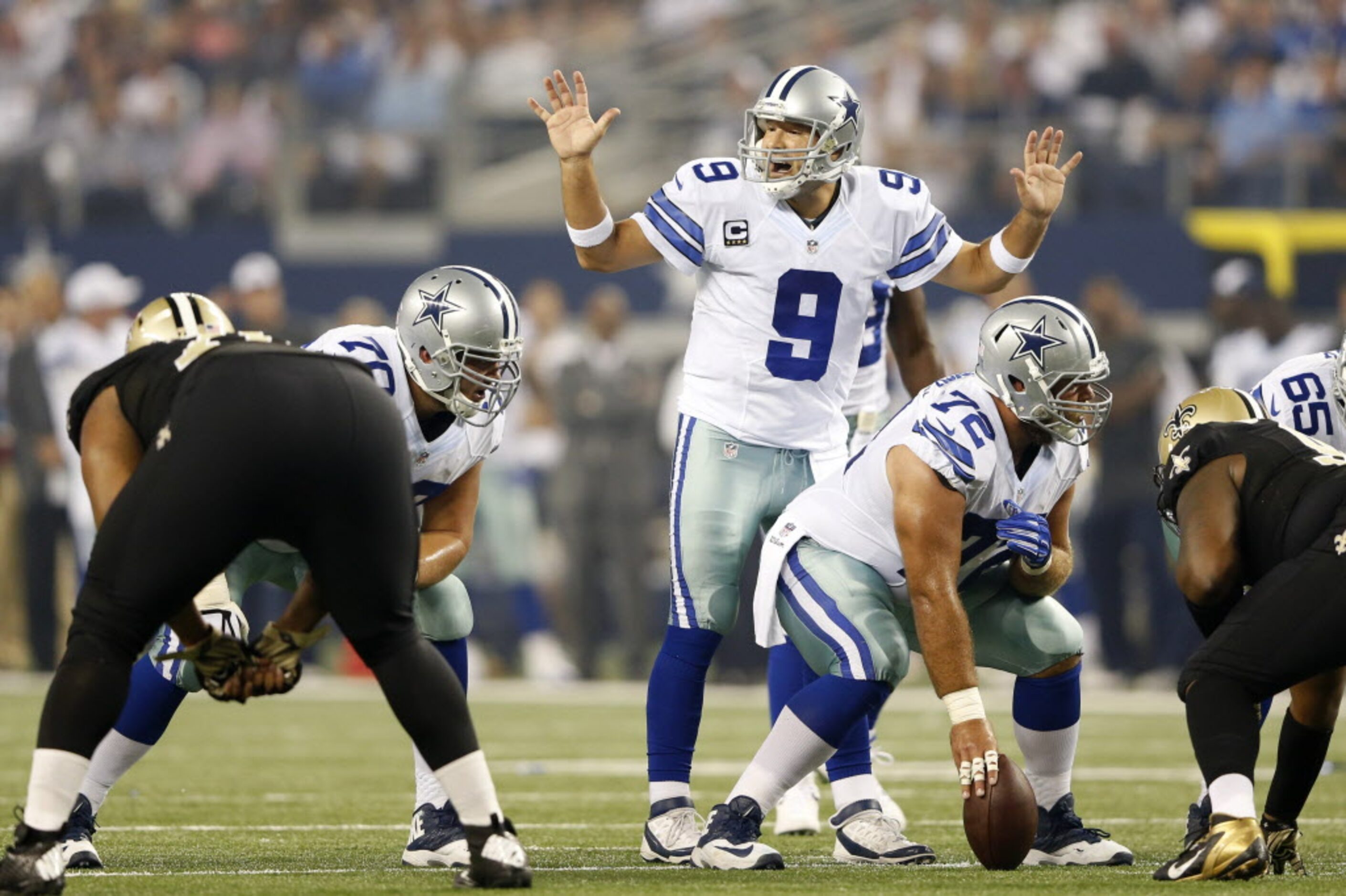 Dallas Cowboys quarterback Tony Romo (9) communicates to his teammates before the snap in a...