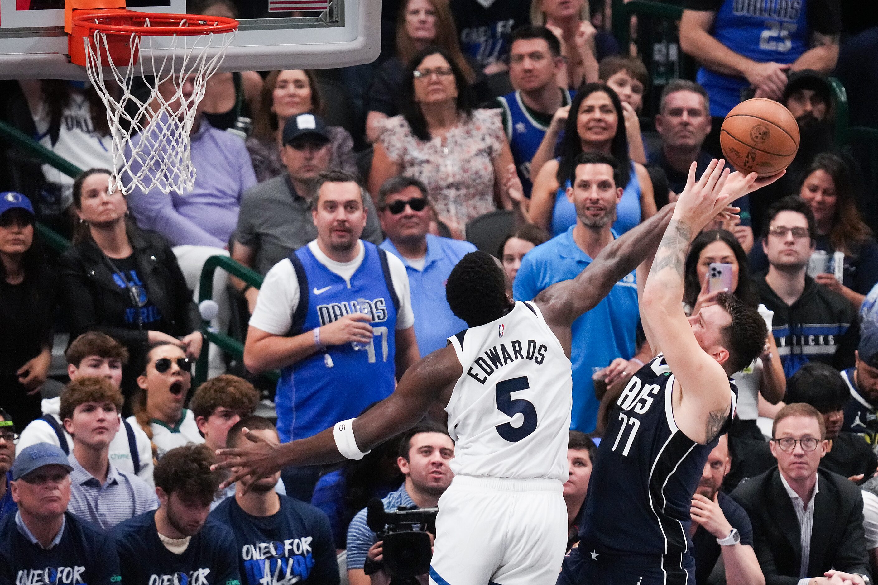 Dallas Mavericks guard Luka Doncic (77) is fouled by Minnesota Timberwolves guard Anthony...