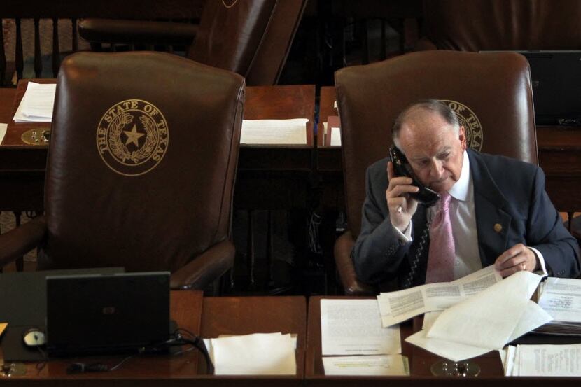 State representative Dan Flynn, R-Canton, works the phones during a break in the Sunday...