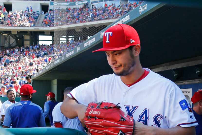 Texas Rangers starting pitcher Yu Darvish (11) leaves the dugout to take the mound during...