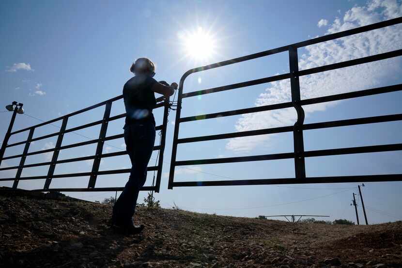 Gilda Jackson opens a gate on her property in Paradise, Texas, Monday, Aug. 21, 2022. The...
