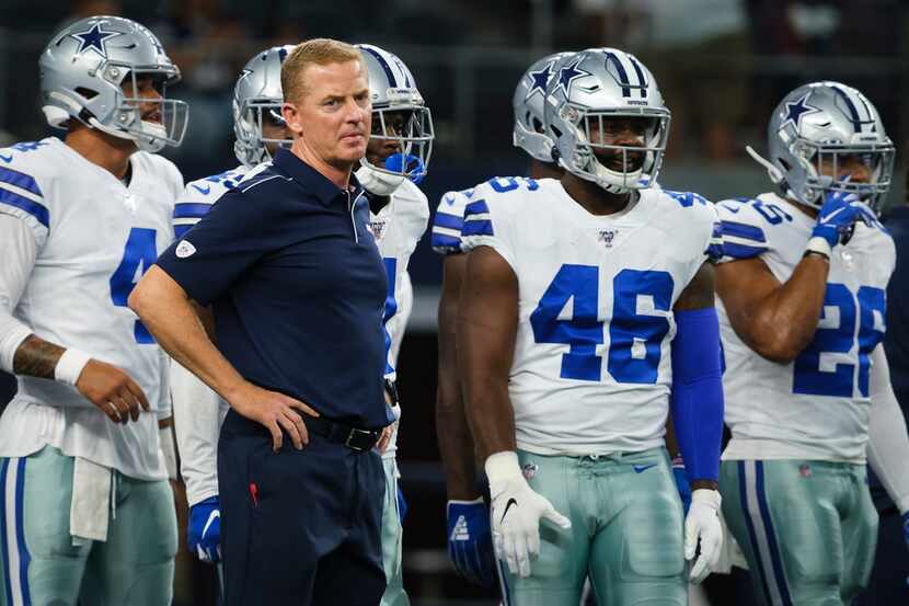 Dallas Cowboys head coach Jason Garrett watches his team warm up before an NFL preseason...