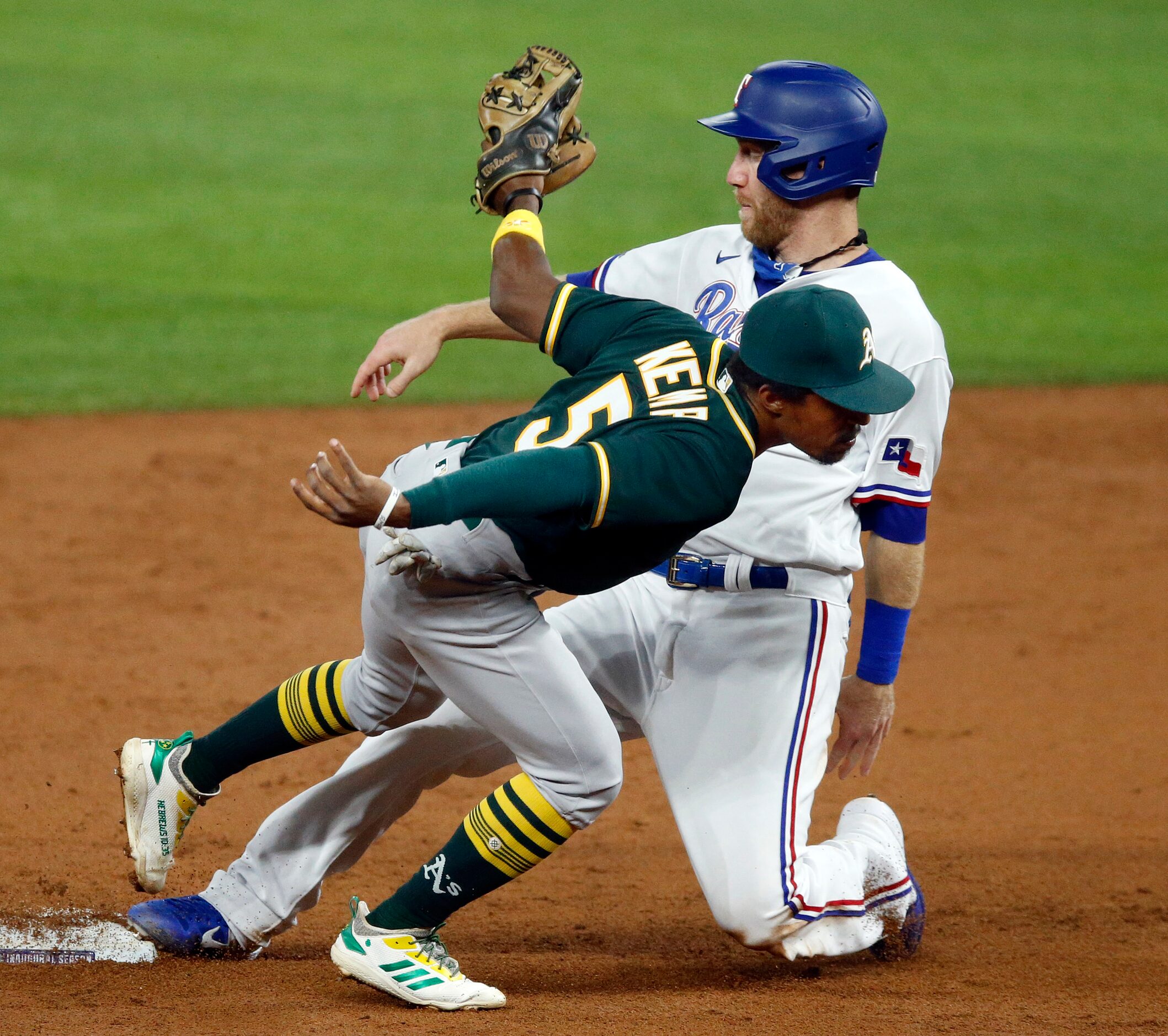 Texas Rangers Todd Frazier is tagged out by Oakland Athletics second baseman Tony Kemp (5)...