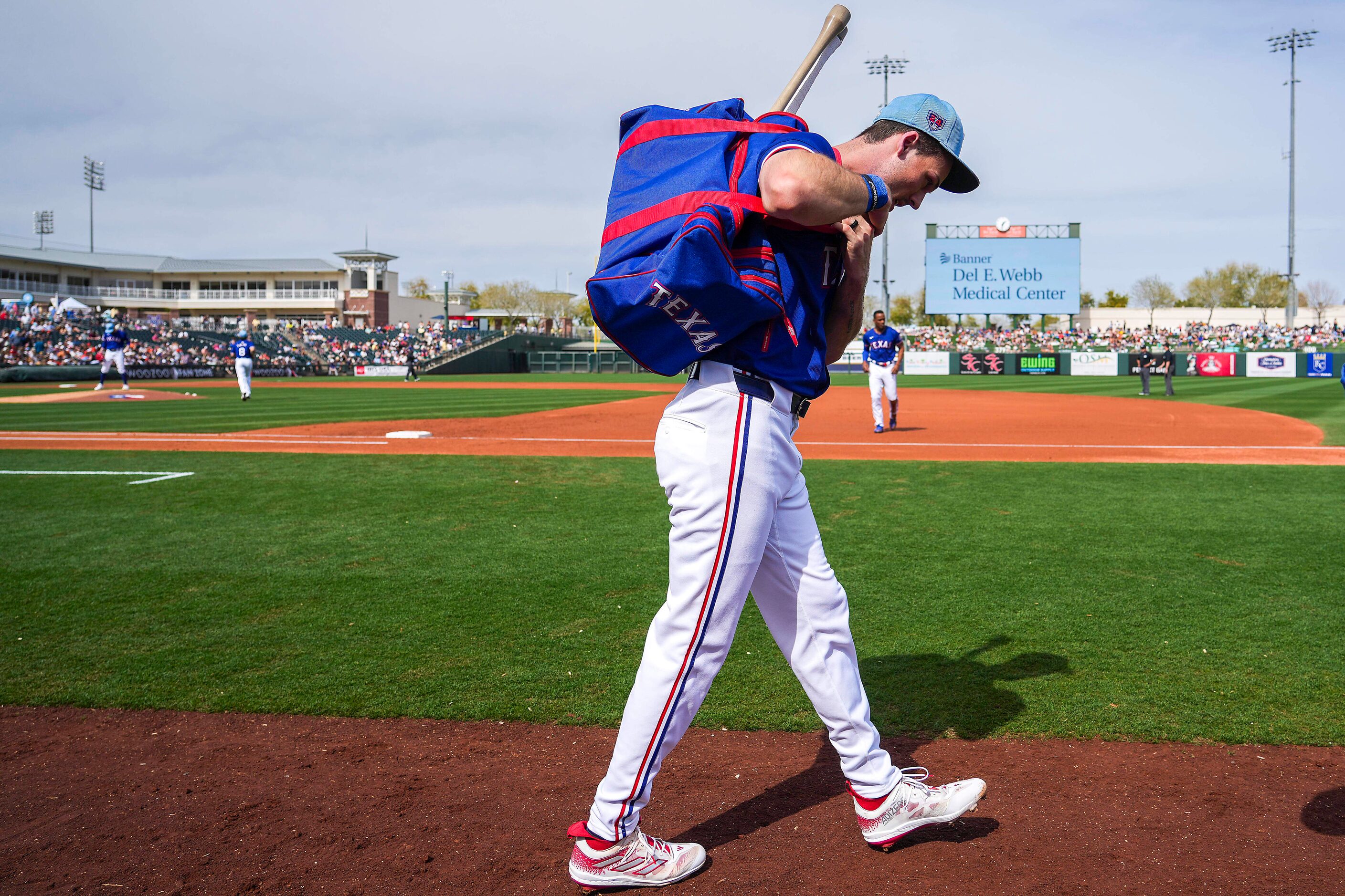 Texas Rangers outfielder Evan Carter leaves the game after being hit by a pitch during the...