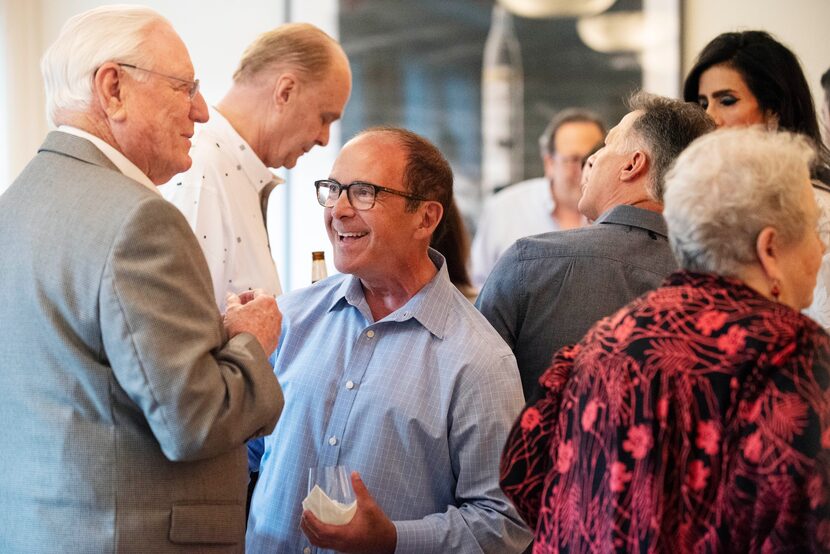 Supporter Charles Matthews, left, speaks with Leland Burk, candidate for Dallas City Council...