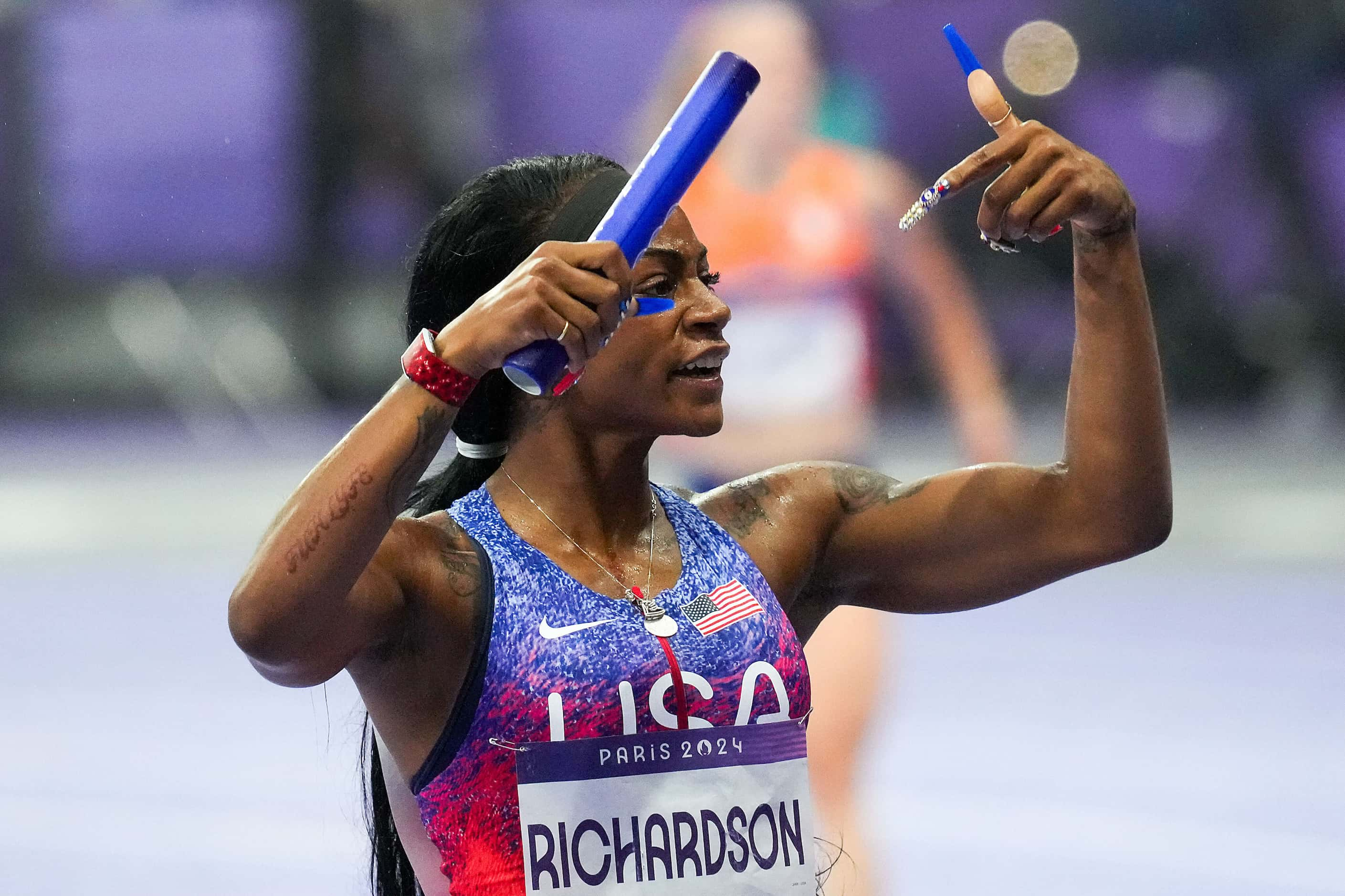 Sha'carri Richardson of the United States celebrates after crossing the finish line to win...