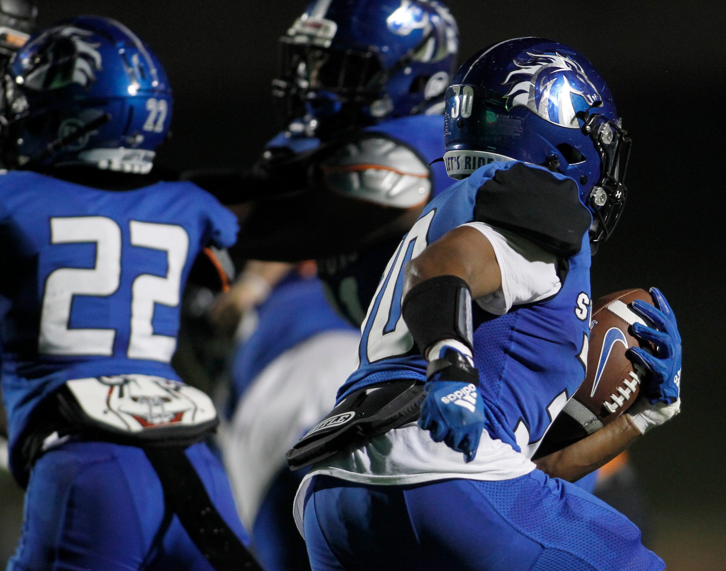 North Mesquite running back Michael Gibson (30) looks for a running lane as he secures the...