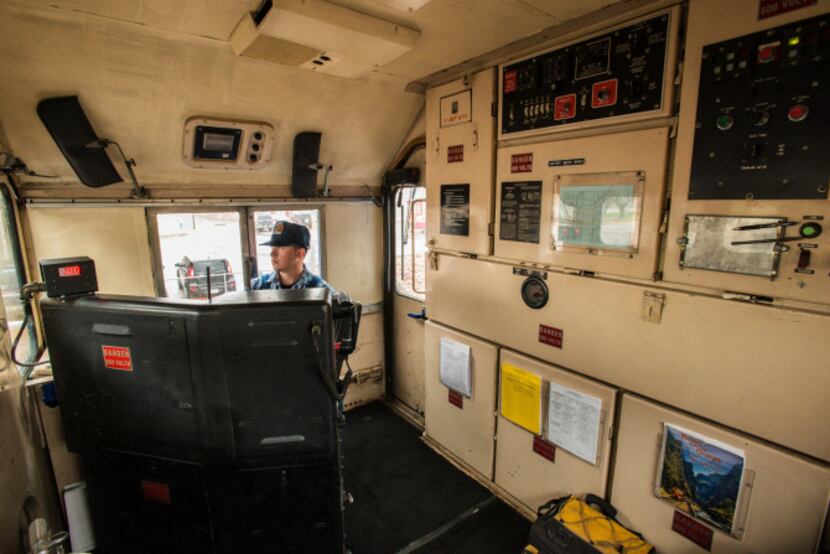 Engineer trainee Devon Cacy sits at the controls. The locomotive cab may not be fancy, but...
