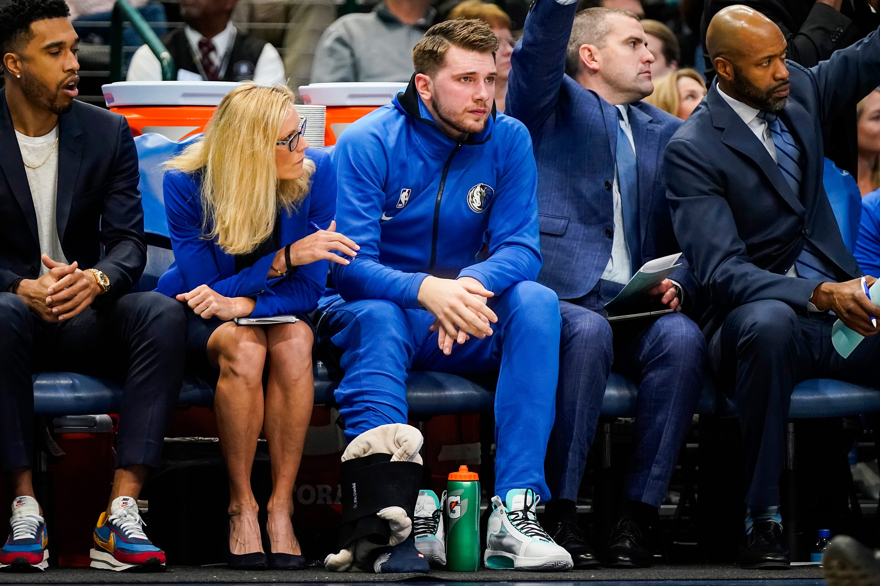 Dallas Mavericks guard Luka Doncic ices his right ankle on the bench during the first half...